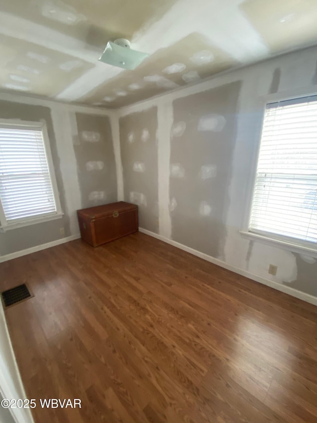 spare room featuring dark hardwood / wood-style flooring