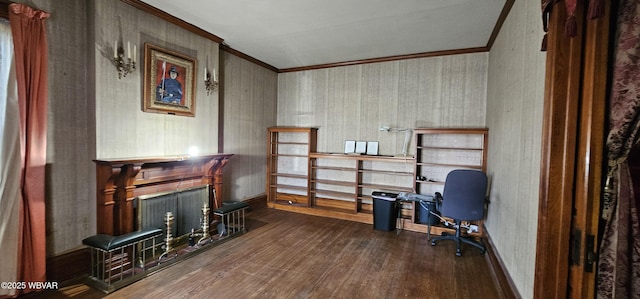 office area featuring a fireplace, wood finished floors, crown molding, and baseboards