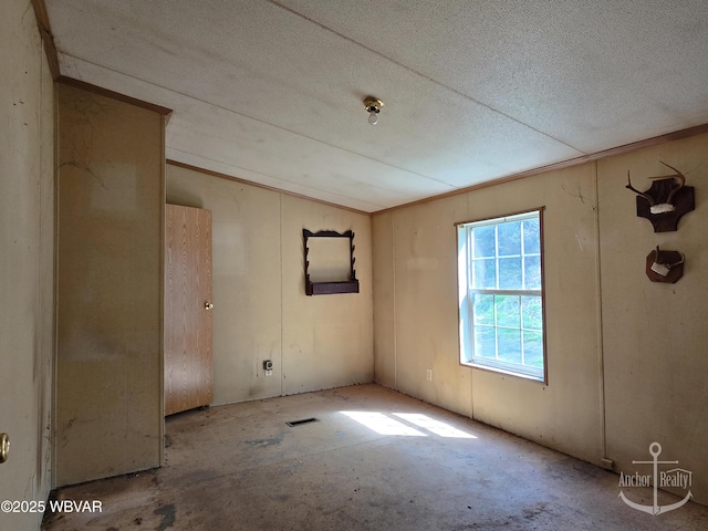 unfurnished room featuring a textured ceiling and visible vents