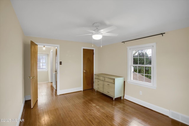 unfurnished bedroom with ceiling fan and light hardwood / wood-style flooring