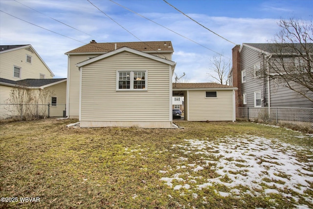 rear view of property featuring a lawn