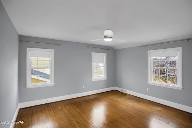 empty room with hardwood / wood-style flooring and ceiling fan