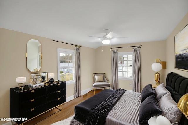 bedroom featuring multiple windows, ceiling fan, and light hardwood / wood-style floors