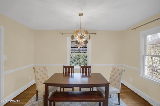 dining area with plenty of natural light and wood-type flooring