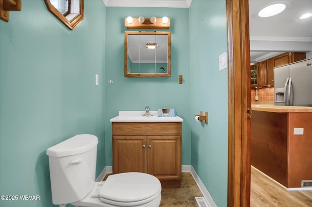 bathroom featuring ornamental molding, vanity, backsplash, and toilet