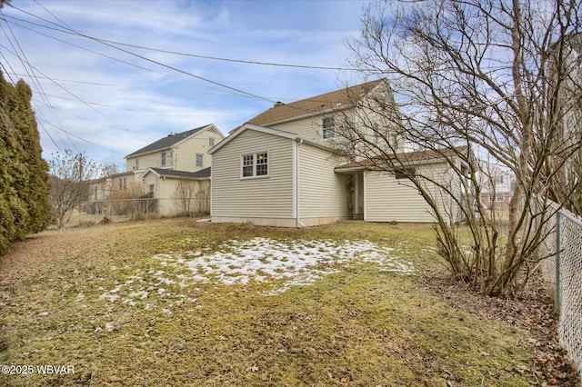 back of property featuring a lawn