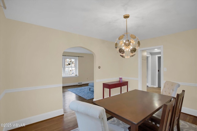 dining room featuring dark hardwood / wood-style floors and a chandelier