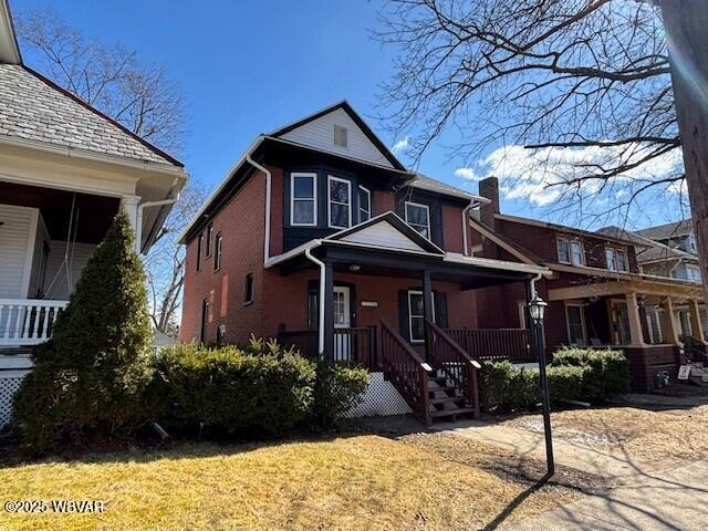 view of front of property with a porch and a chimney