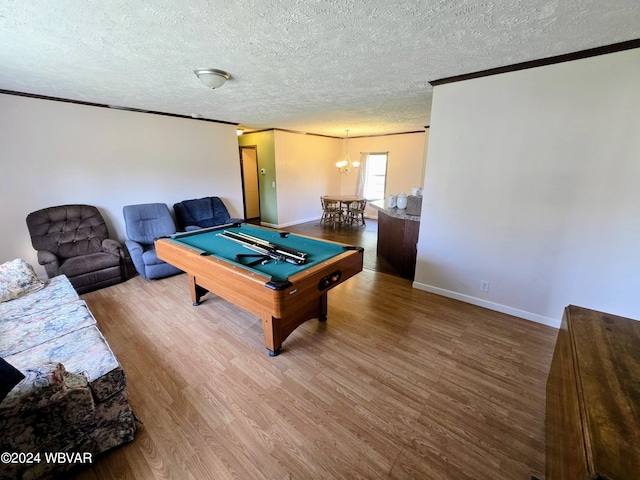 recreation room with a chandelier, a textured ceiling, hardwood / wood-style flooring, and pool table