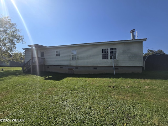 rear view of property with a yard