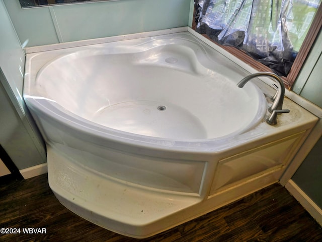 bathroom featuring a bath and hardwood / wood-style flooring