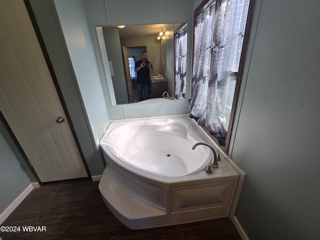 bathroom featuring hardwood / wood-style floors and a bath