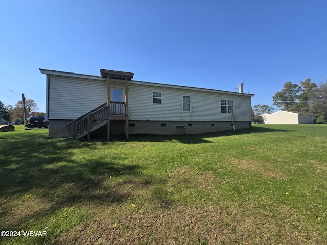 rear view of property featuring a lawn