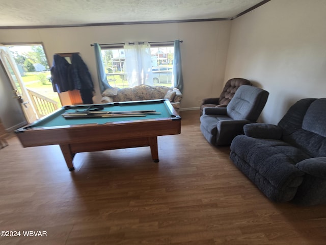 playroom with wood-type flooring, a textured ceiling, crown molding, and billiards