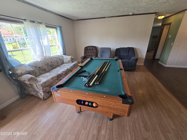 playroom featuring hardwood / wood-style floors, ornamental molding, a textured ceiling, and pool table