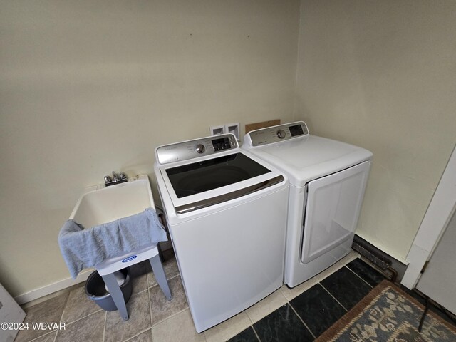 washroom with light tile patterned flooring and washing machine and clothes dryer