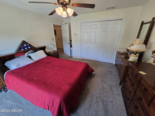 carpeted bedroom featuring a closet and ceiling fan