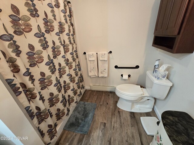 bathroom with hardwood / wood-style flooring, toilet, walk in shower, and a baseboard radiator