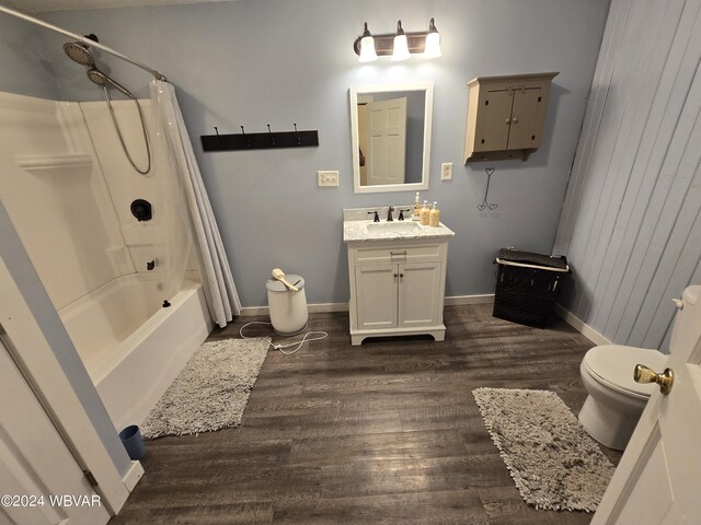 full bathroom featuring vanity, hardwood / wood-style flooring, toilet, and shower / bathtub combination with curtain