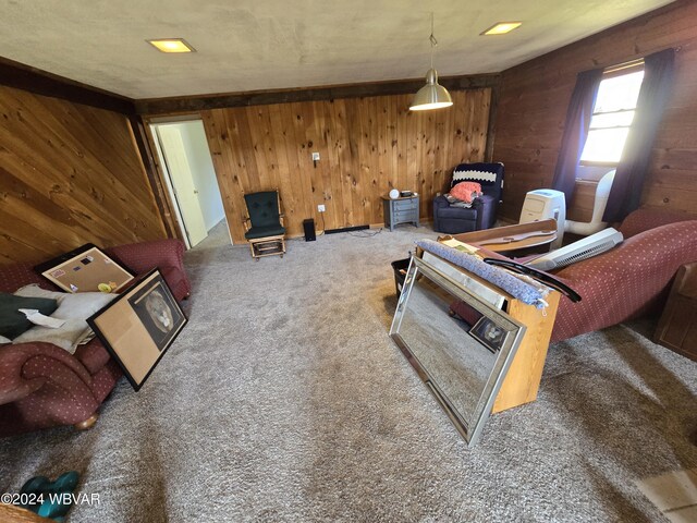 living room featuring carpet flooring and wood walls