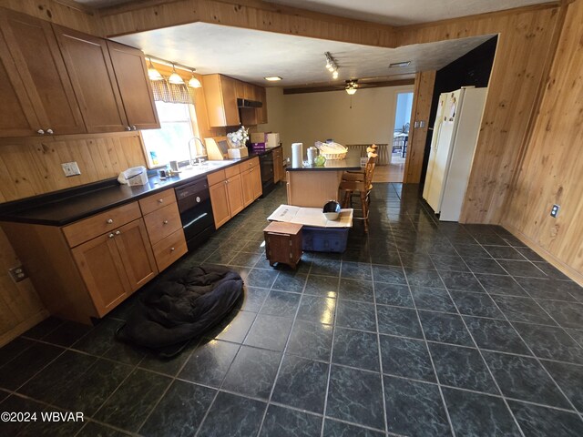 kitchen featuring a center island, wood walls, and black appliances