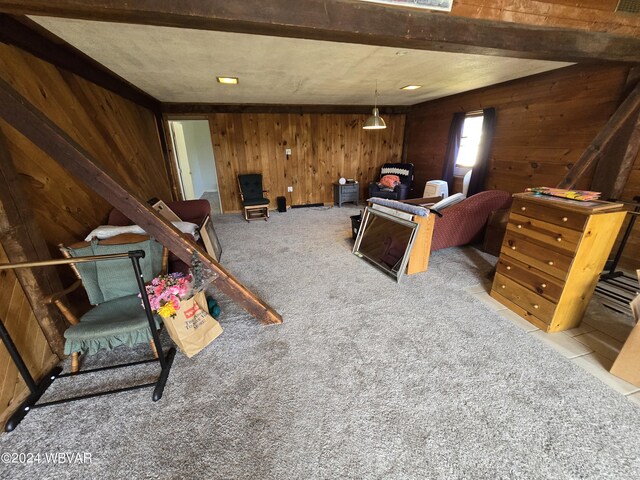 interior space with light colored carpet and wooden walls