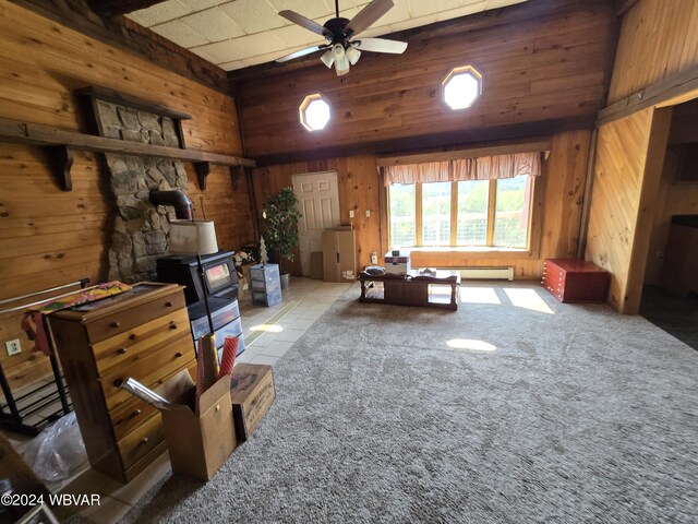 misc room featuring ceiling fan, wood walls, light tile patterned floors, and baseboard heating