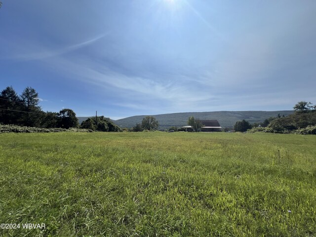 exterior space with a mountain view and a rural view