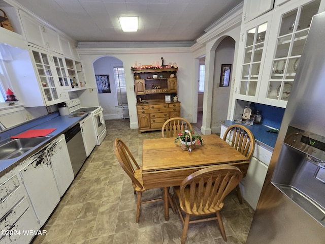 dining space featuring ornamental molding and sink