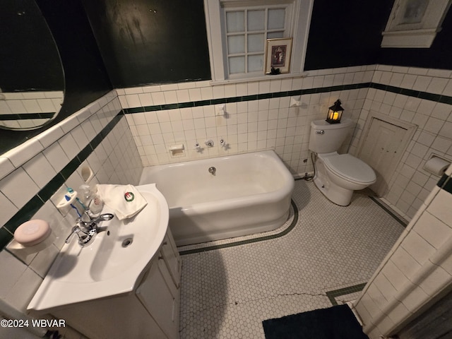 bathroom with a tub, sink, tile patterned floors, toilet, and tile walls