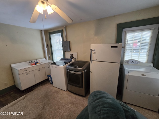 laundry area featuring carpet flooring, electric panel, washer and clothes dryer, and ceiling fan