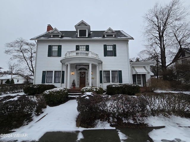 colonial home featuring a balcony