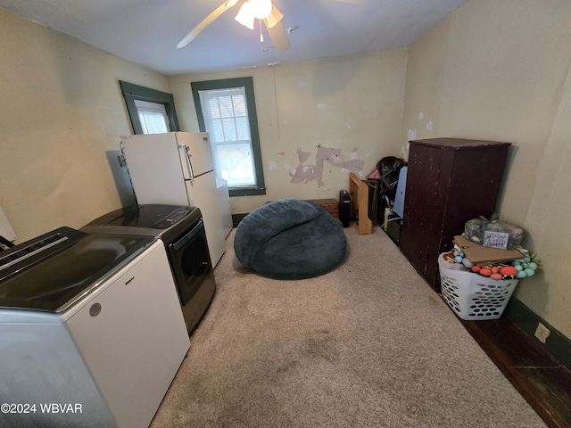 laundry area with ceiling fan, dark carpet, and washing machine and dryer