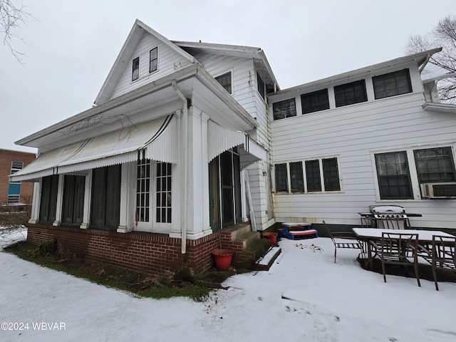 snow covered house with cooling unit