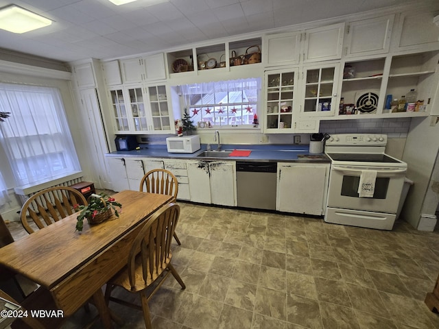 kitchen featuring white cabinetry, white appliances, and sink