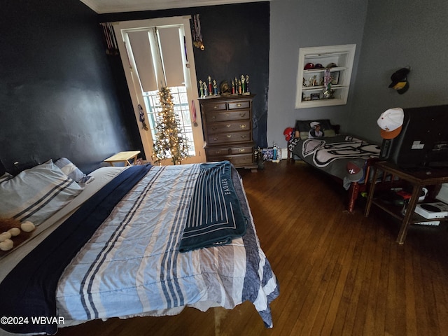 bedroom featuring hardwood / wood-style floors and crown molding