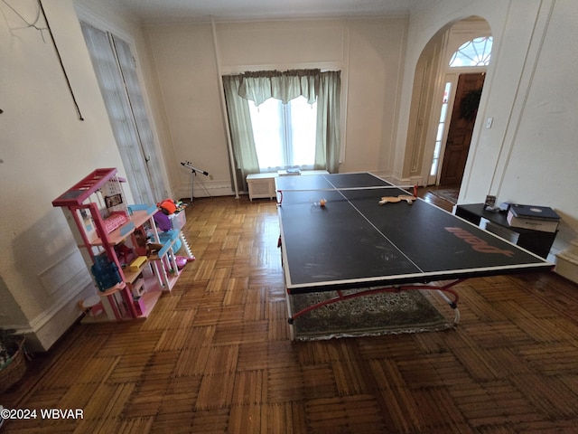 playroom featuring dark parquet flooring and radiator