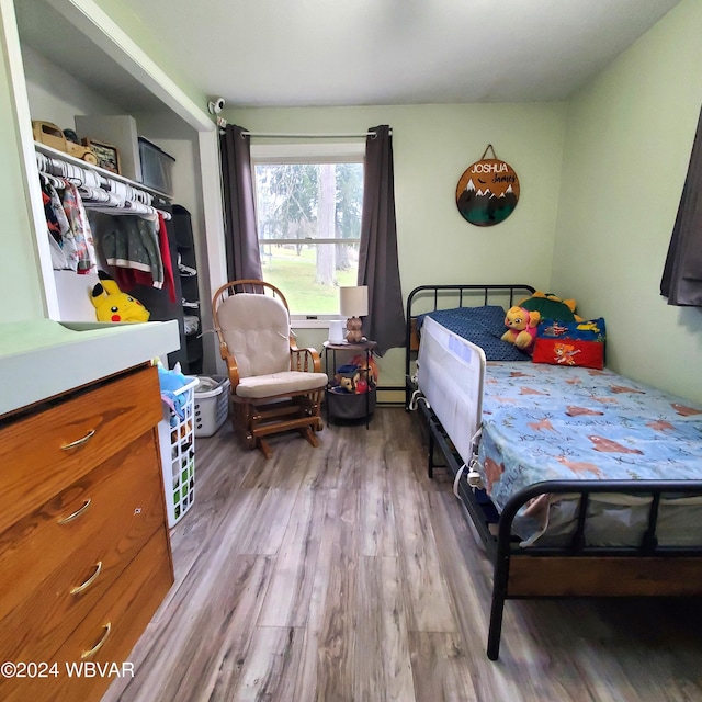 bedroom featuring light hardwood / wood-style floors and baseboard heating