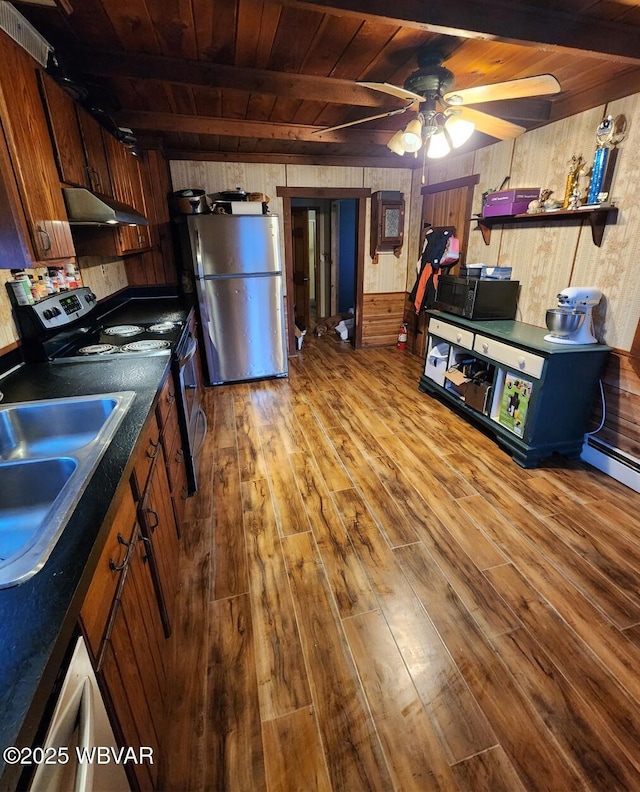 kitchen with beam ceiling, wood ceiling, light hardwood / wood-style flooring, and stainless steel appliances