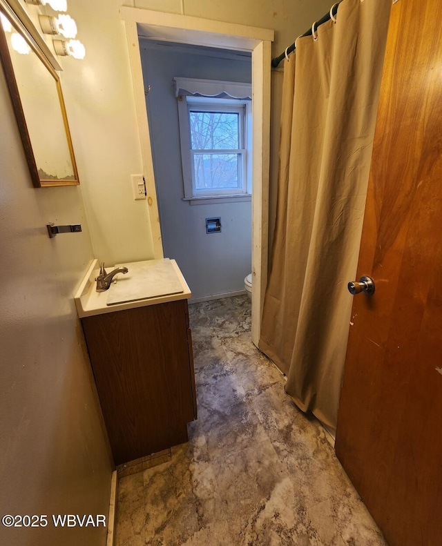 bathroom featuring vanity and toilet