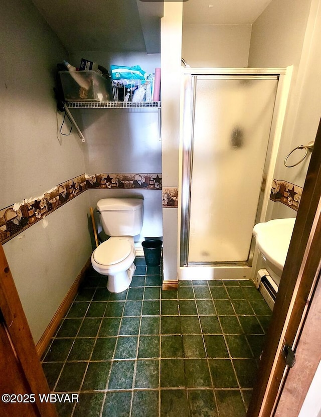 bathroom with a baseboard radiator, toilet, a shower with shower door, and tile patterned flooring