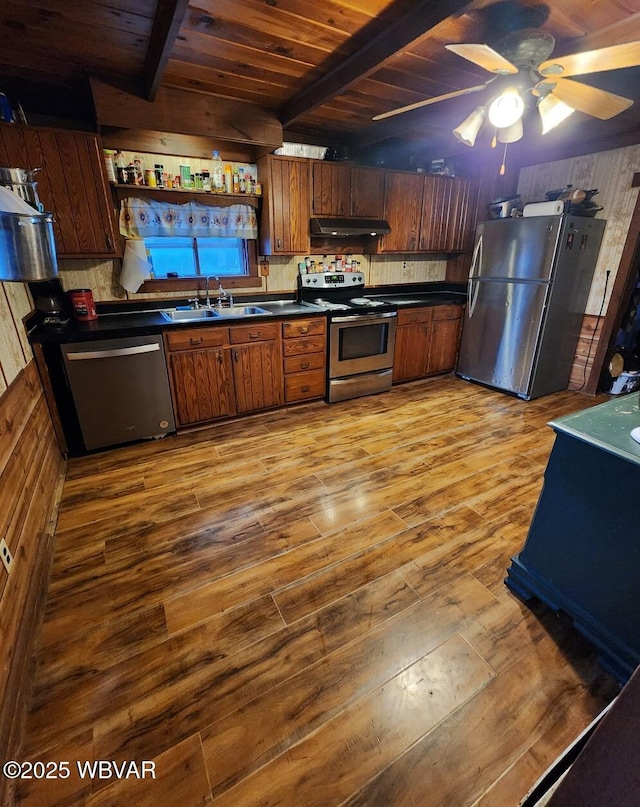 kitchen with sink, beam ceiling, light hardwood / wood-style flooring, and stainless steel appliances