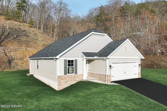 view of front of home with a garage and a front yard