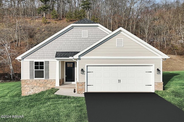 view of front of house featuring a garage and a front lawn