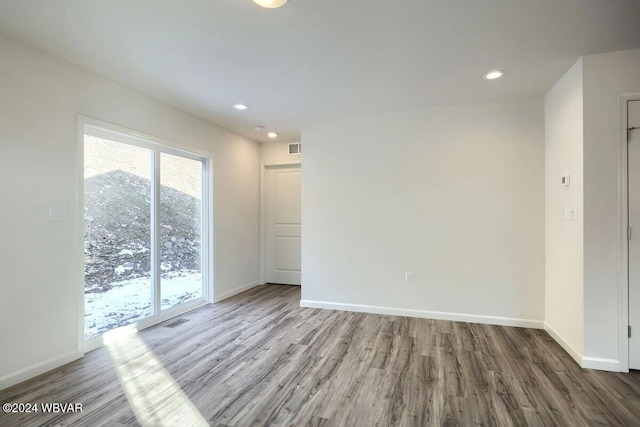 unfurnished room with wood-type flooring