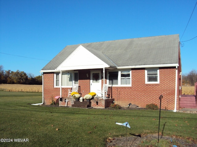 view of front facade featuring a front lawn and covered porch