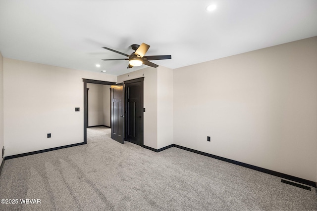 empty room with visible vents, recessed lighting, baseboards, light colored carpet, and ceiling fan