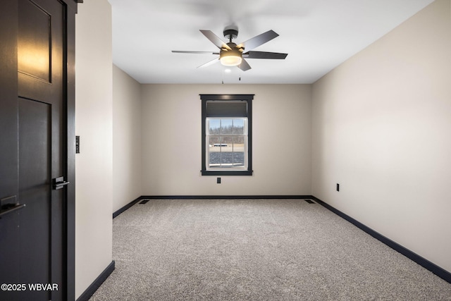 unfurnished room featuring baseboards, carpet floors, and ceiling fan