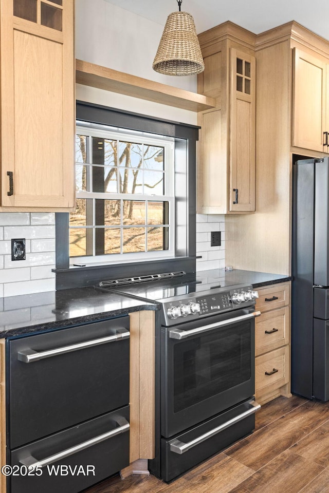 kitchen with light brown cabinetry, tasteful backsplash, electric range oven, and freestanding refrigerator