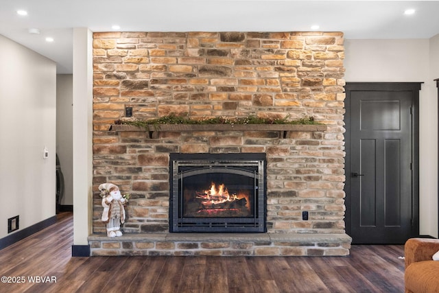 details with recessed lighting, wood finished floors, baseboards, and a large fireplace